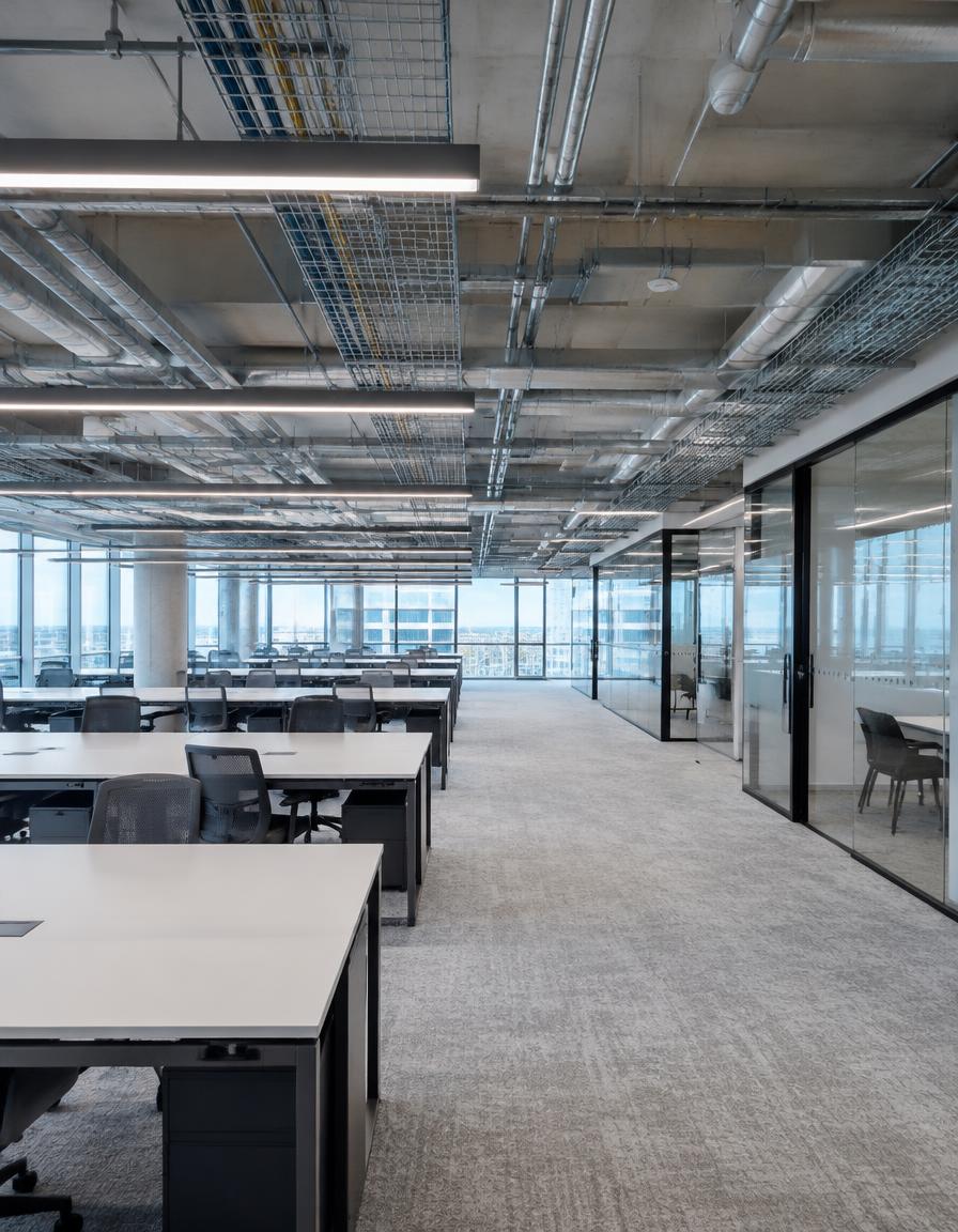 Large open-plan commercial office fitout with exposed cable trays
